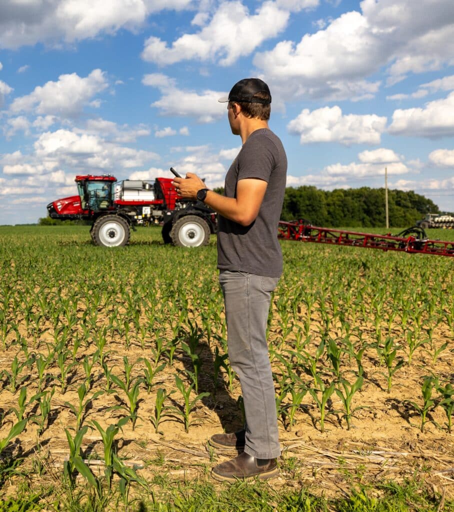 Agronomist reviewing field map on a device