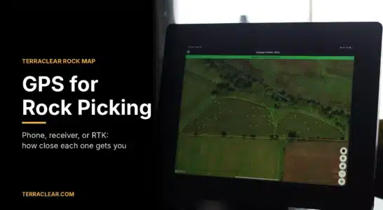 Tablet in a tractor cab showing a TerraClear Rock Map, used for GPS-guided rock picking