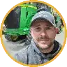 Matthew Pueppke, farmer near Erie, North Dakota, in front of a green tractor